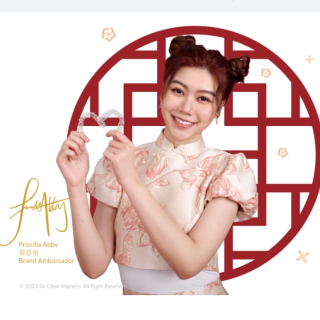 Woman holding two invisible braces Dr Clear Aligners