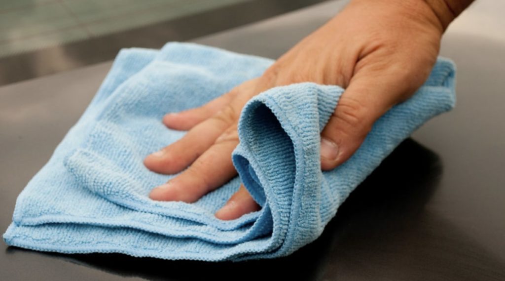 Saturating a cloth with a cleaner