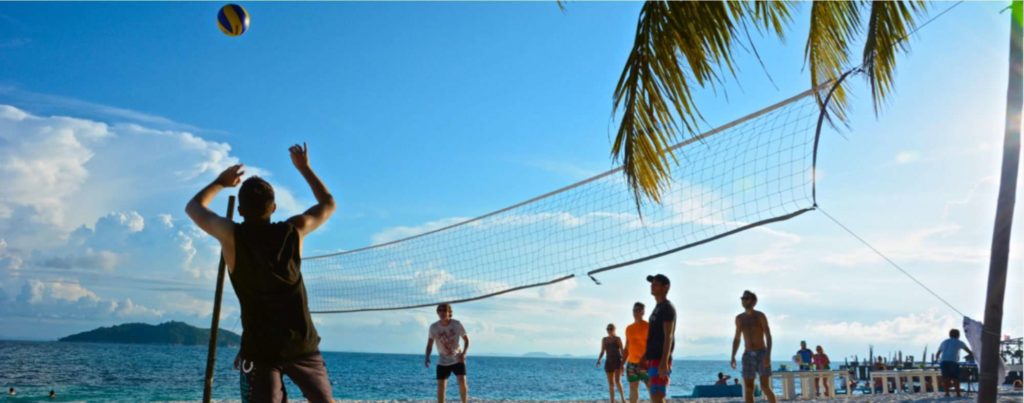 Play beach volleyball